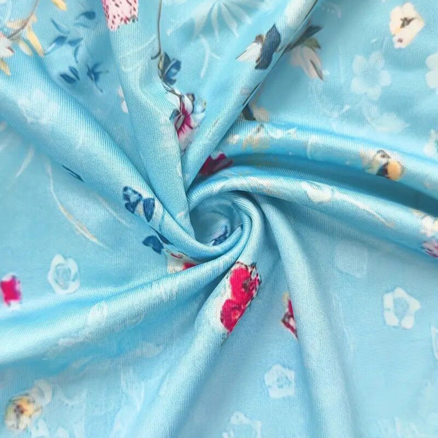 Close-up of blue fabric with floral and animal prints