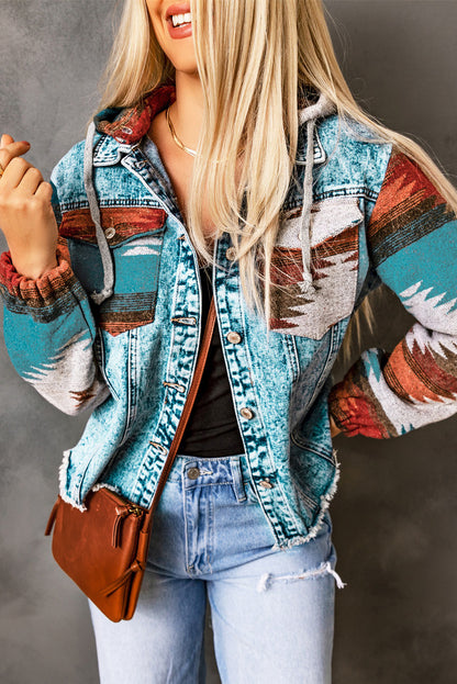 Woman wearing an Aztec print denim jacket with frayed hem and colorful sleeves, styled with jeans and a brown crossbody bag”