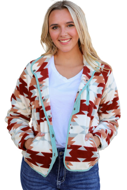 Woman wearing a patterned cardigan with a blurred outdoor background
