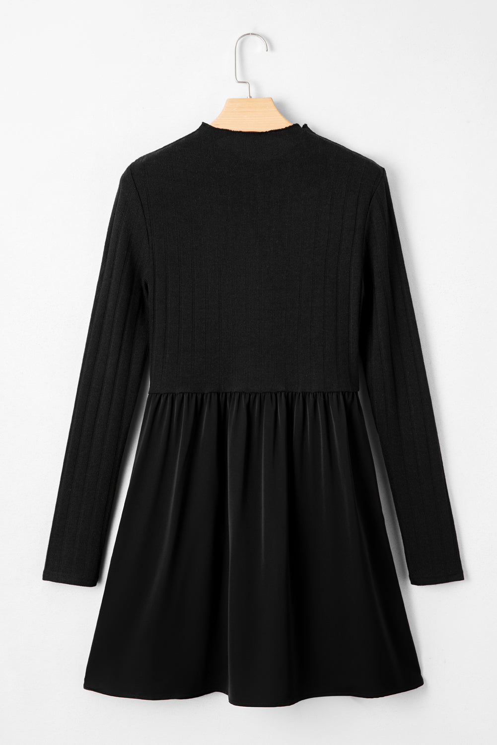 Black long-sleeve skater dress displayed on a wooden hanger against a white background.”