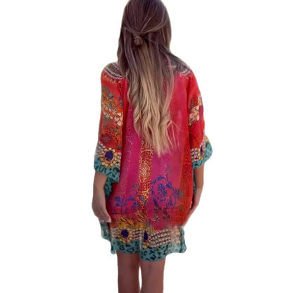Person wearing a colorful embroidered dress with a white background
