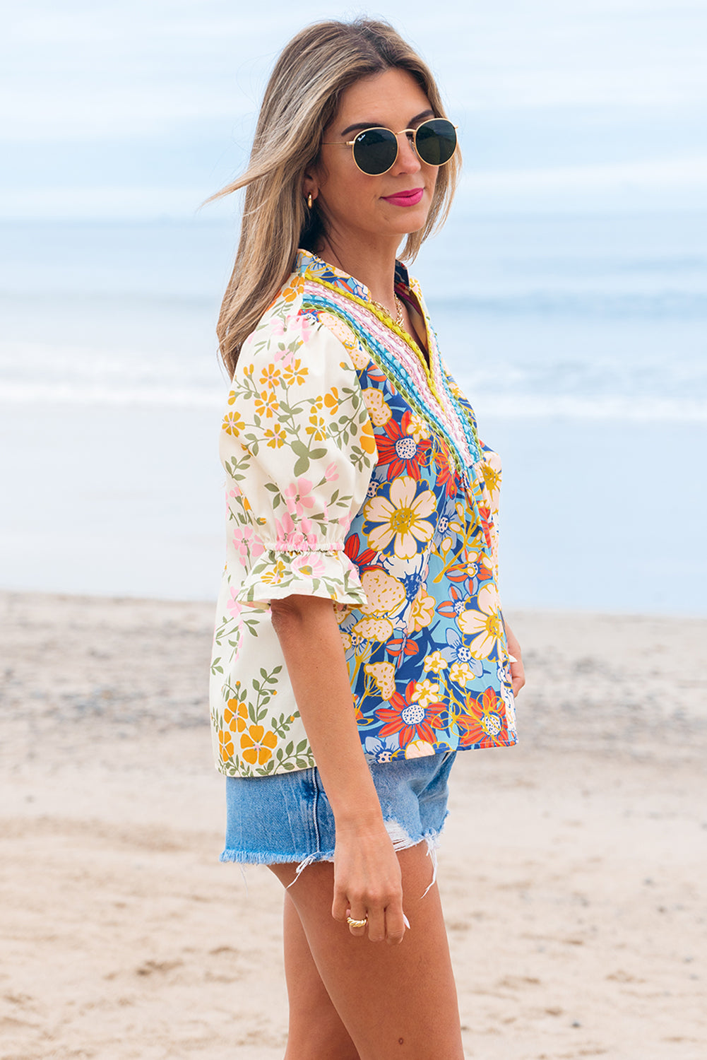 Woman wearing a colorful floral kimono on a beach
