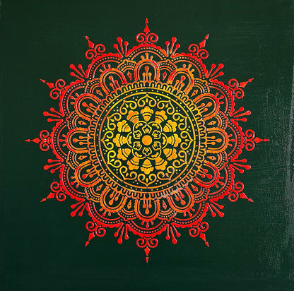 Decorative mandala with red and orange colors on a green background
