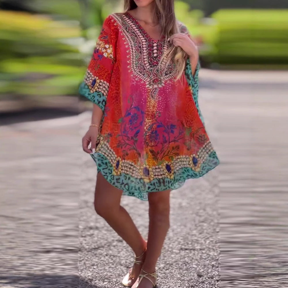 Woman wearing a colorful dress with floral patterns by a poolside.