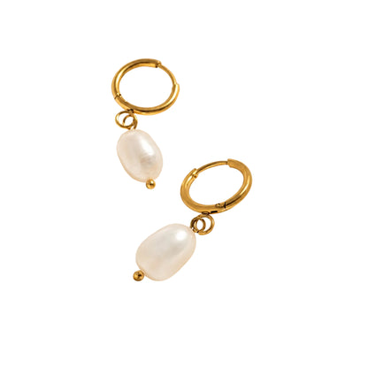 Gold hoop earrings with pearls on a satin surface